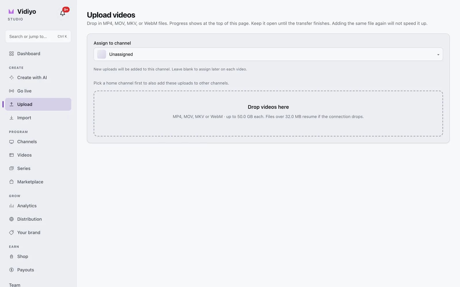 The Upload videos page in Vidiyo Studio with an Assign to channel dropdown set to Unassigned and a dashed Drop videos here area listing accepted formats and the 50 GB limit.